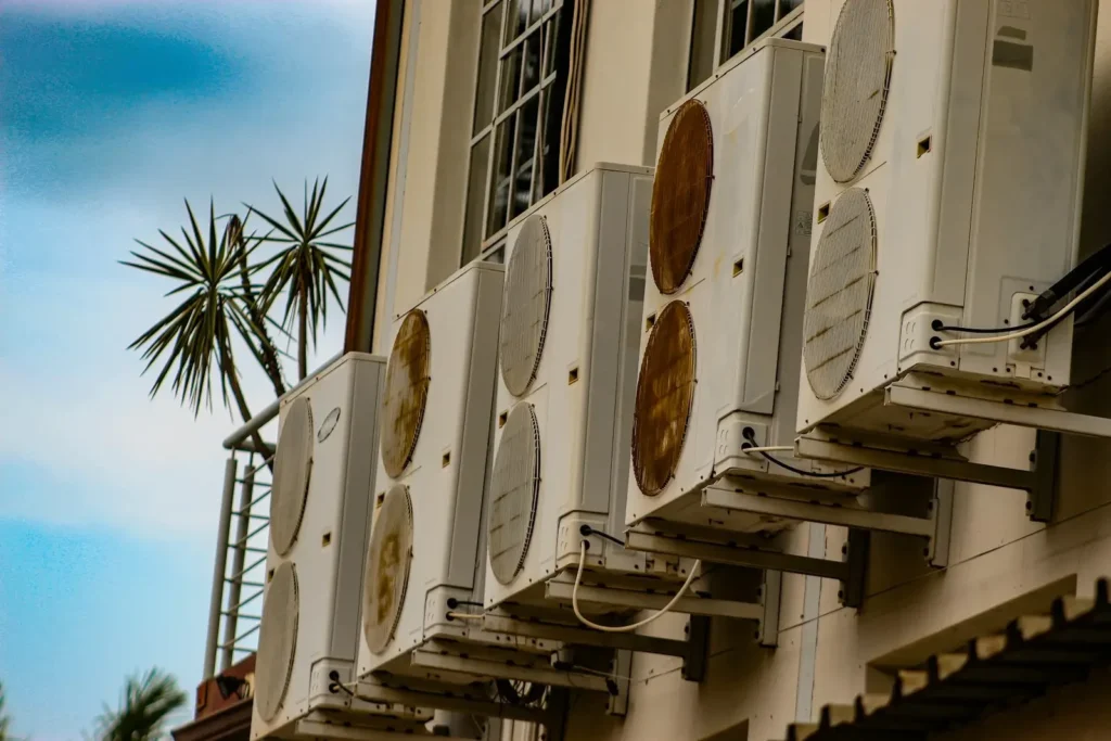 Multiple air conditioning units mounted on a building.